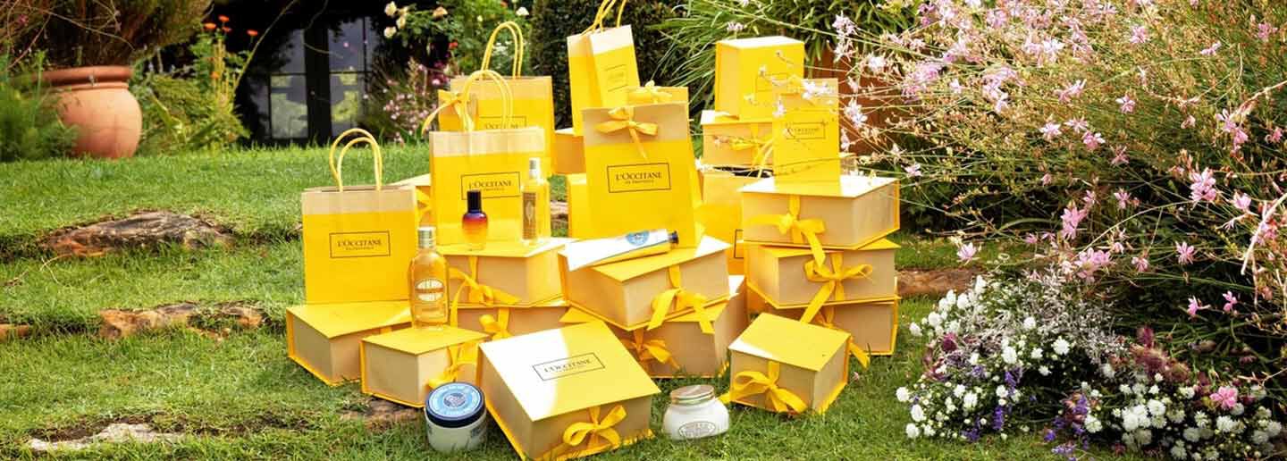 l'occitane yellow gift bags with best sellers on grass